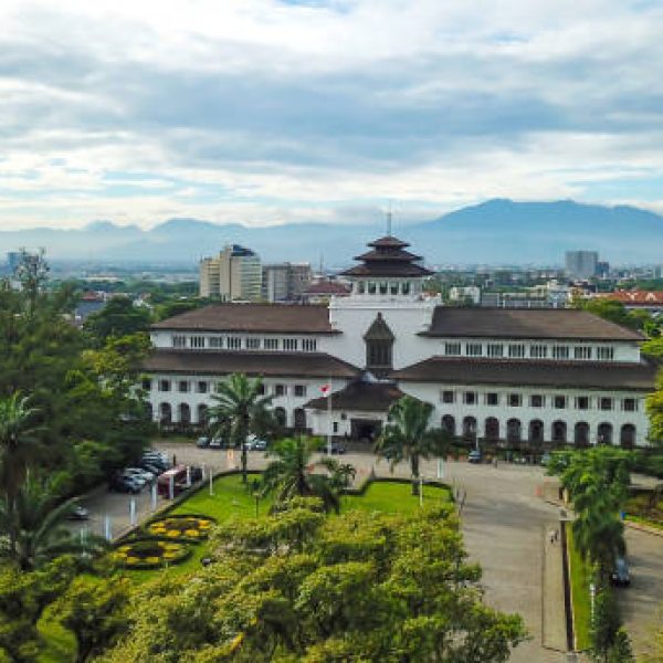Aerial view of Gedung Sate, Bandung, West Java, Indonesia with beautiful sky and city landscape. Old Historical building with art decoration style, Governor Office